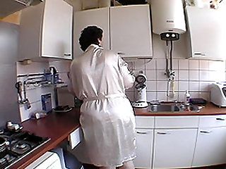Mature damsel preparing tea then showcasing her pussy